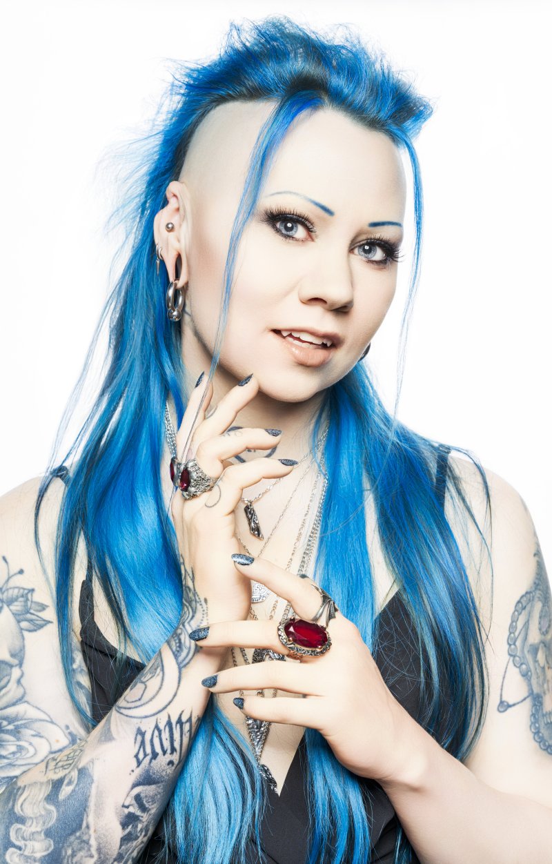 Closeup portrait of woman with blue hair and tatoo's