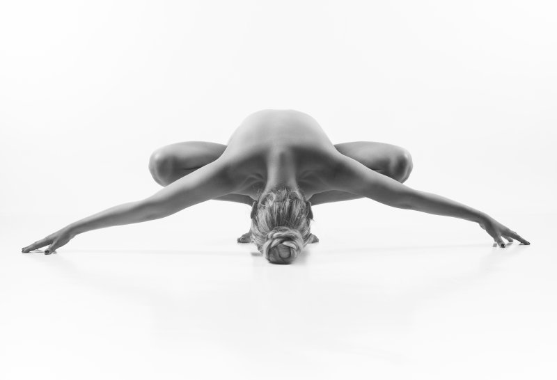 Woman performing a yoga pose in studio