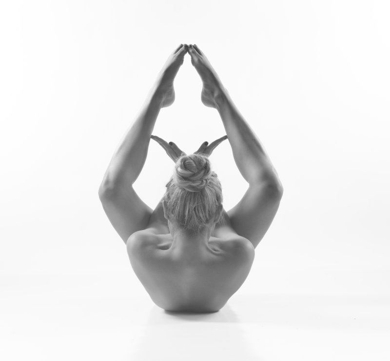 Woman performing a yoga pose in studio