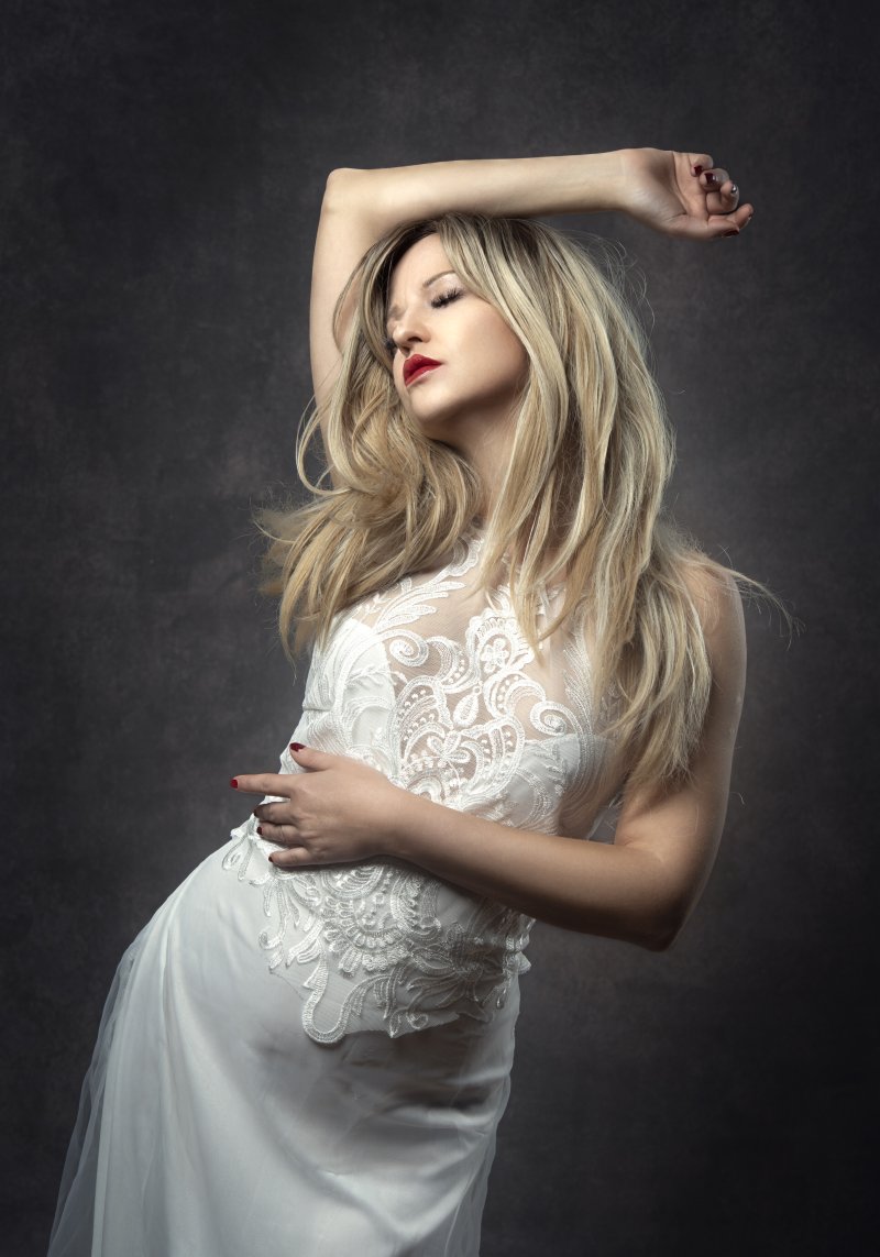 Woman posing in studion wearing a wedding dress